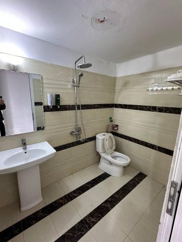 a bathroom with a sink and a toilet and a shower at Thiên Thiên Thanh in Lao Cai