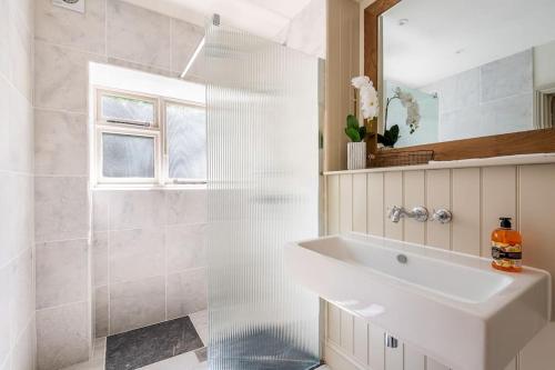 a bathroom with a sink and a shower at Large Historic Secret Hideaway in Moreton in Marsh