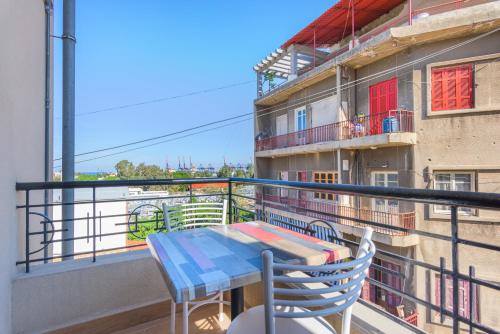 a balcony with a table and chairs on a building at 961 Station Apartments in Mar Mikhael in Beirut