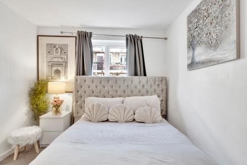 a white bedroom with a bed with two pillows at Large 1 Bed Apartment by London Bridge Tower Bridge Secure Parking - Perfect for Long Stays in London