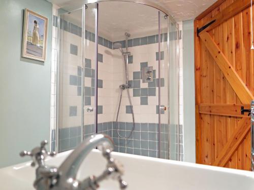 a bathroom with a shower and a sink at 3 Bed in Boscastle 75145 in Boscastle