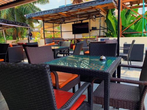 an outdoor patio with tables and chairs and a television at WORK AND PLAY PLACE(WPP) in Ikeja