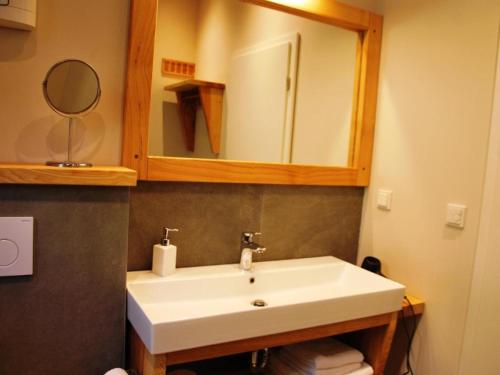 a bathroom with a white sink and a mirror at Ferienhaus Das Kleine Paradies in Liebenau
