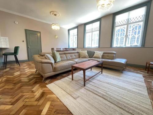a living room with a couch and a table at Cathedral View Apartment, Flat 4 in Bury Saint Edmunds