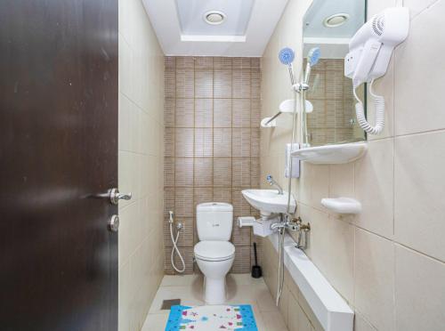 a bathroom with a toilet and a sink at Zapbed House- AWP 2605 in Dubai