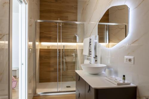 a bathroom with a sink and a shower at Cas’ A Mare - Beachfront Luxury Suites in Salerno