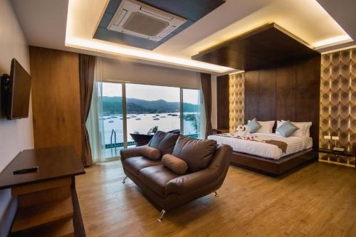 
a living room filled with furniture and a window at Phi Phi Cliff Beach Resort-SHA Plus in Phi Phi Don
