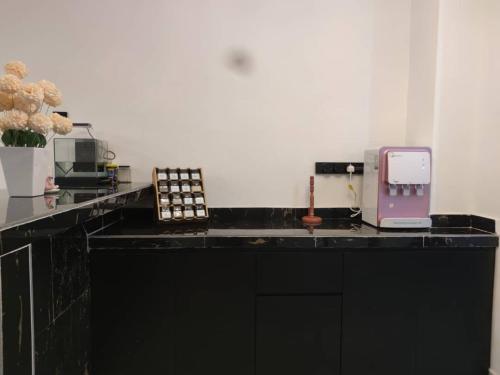 a black counter with a phone on top of it at khisya homestay in Kuantan