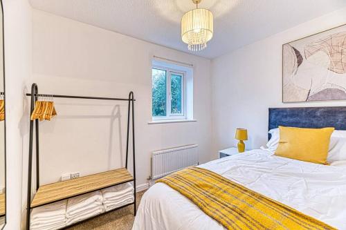a bedroom with a bed and a chandelier at Cosy 2 Bedroom Flat Chester in Chester