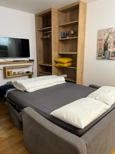 une chambre avec un lit et une télévision à écran plat dans l'établissement Superbe studio Paris La Défense, à La Garenne-Colombes