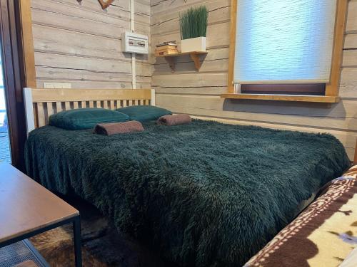 a bedroom with a large bed in a room at Pirtelė Arjola in Kaltanėnai