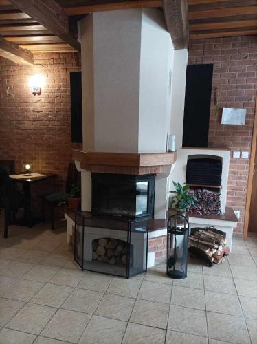 a fireplace in a room with a brick wall at Penzión Turzov in Gelnica