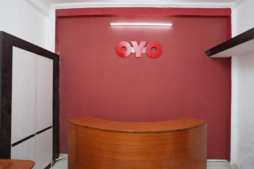a red wall with the ovy sign on it at Collection O The Vinayak in Bhopal