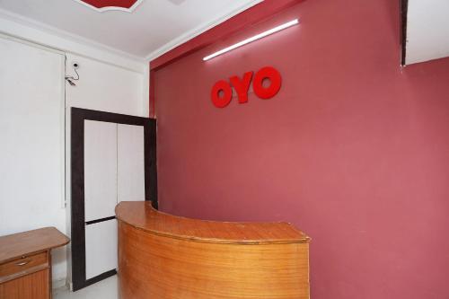 a red wall with the oo sign on it at Collection O The Vinayak in Bhopal