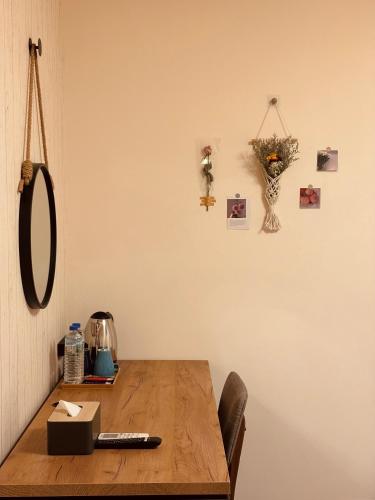 a wooden table with a mirror on a wall at The Green Mile Field B&B in Jian