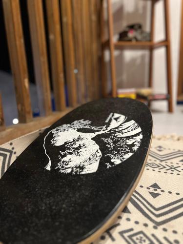 a black surfboard with a picture of a woman on it at Sunny Terrace in Baler