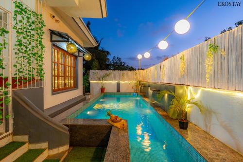 a swimming pool in the backyard of a house at EKO STAY- CASA VAGA in Vagator