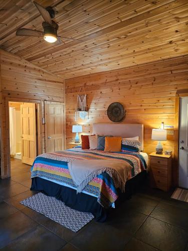 a bedroom with a bed in a wooden cabin at Honey Bear Haven Suite 4 in Eureka Springs