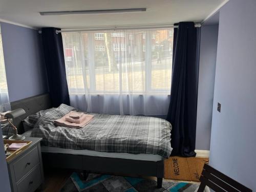 a small bedroom with a bed and a window at Cozy Guest Room in High Barnet (London) with Private Entrance and Small Terrace in London