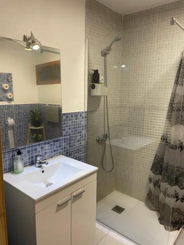 a bathroom with a sink and a shower at Hostal El Alba in Brunete