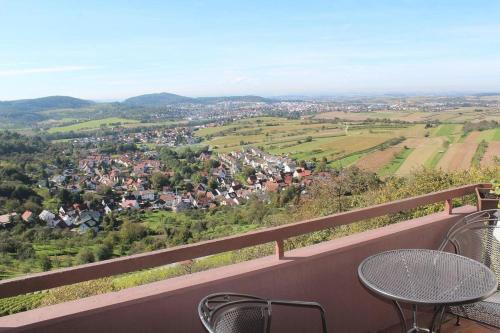 a table and chairs on a balcony with a view at Burghotel Schöne Aussicht Bauer GmbH in Winnenden