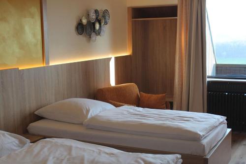 a hotel room with two beds and a window at Burghotel Schöne Aussicht Bauer GmbH in Winnenden