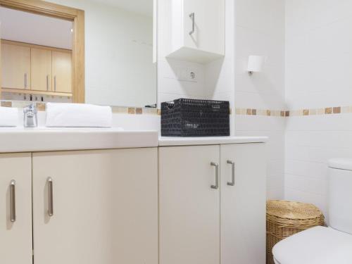 een badkamer met witte kasten en een wastafel bij LOFT TEATRO ~ Alicante in Alicante