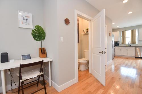 a home office with a desk and a table at Beautiful Home w/ Rooftop Deck Within A 5 Mintue Walk To Johns Hopkins Hospital in Baltimore