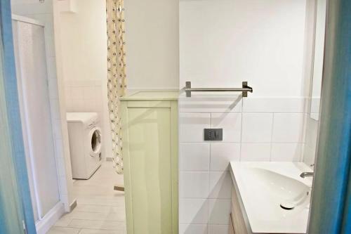 a bathroom with a toilet and a sink and a urinal at Harbor Houses II in Marzamemi