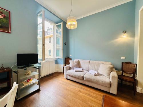 a living room with a couch and a tv at Suite Matteotti 133 - Sanremo in Sanremo