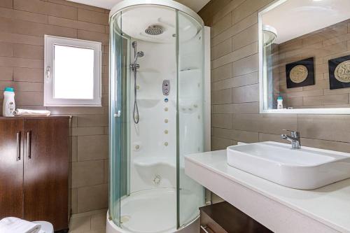 a bathroom with a glass shower and a sink at Amazing Sea Views Santa Pola AC in Santa Pola