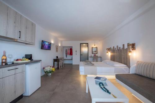 a hotel room with a bed and a living room at Myrsini's Luxury Suites Merchia in Mýkonos City