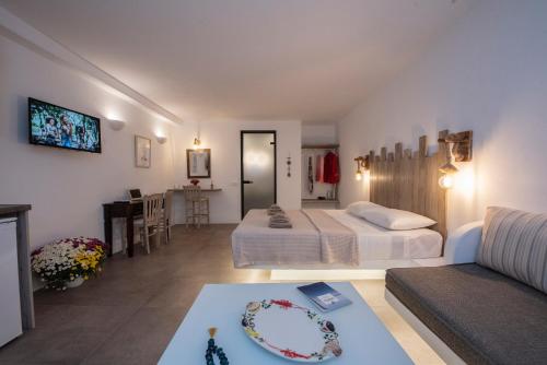 a bedroom with two beds and a living room at Myrsini's Luxury Suites Merchia in Mýkonos City