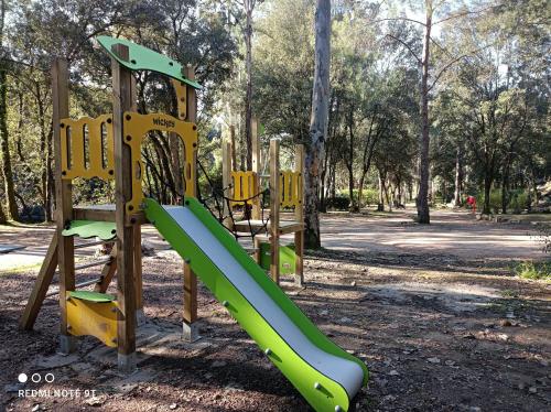 a playground with a slide in a park at Camping Les Eaux Vives in Vero