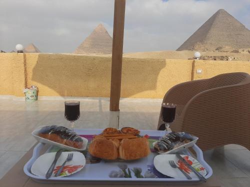 a tray of food on a table in front of the pyramids at Tamara Pyramids Inn in Cairo