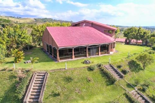 an aerial view of a house with a red roof at Palacial Villa at Lake Arenal in Tilarán