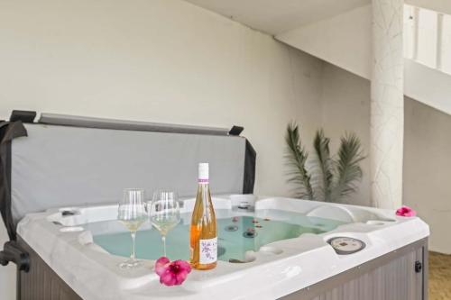 a bath tub with two glasses and a bottle of wine at Outstanding & Huge 600m Private Villa - Pool - BBQ in Coco