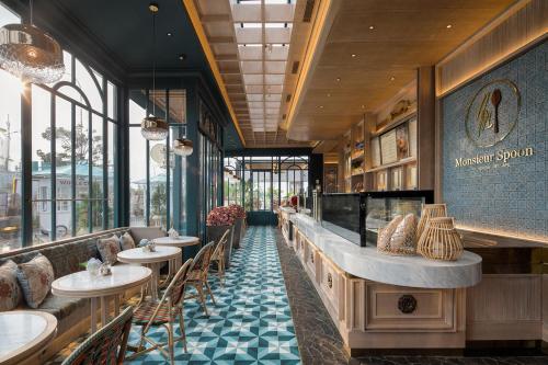 a restaurant with tables and chairs and a counter at 3BR Flat in Taman Anggrek Residence in Jakarta