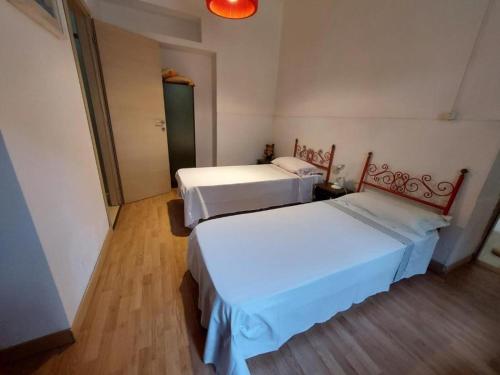 a room with two beds in a room at La Perla al mare 300mt from Perla Marina Beach in Santa Margherita di Pula