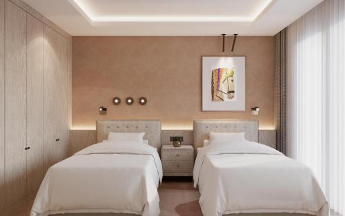 two beds in a bedroom with white sheets at Gloria Golf Resort - Kids Concept in Belek