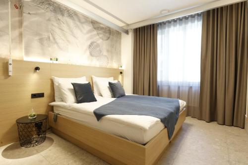 a bedroom with a large bed in a room at FLORAMARE HEALTH RESORT in Izola