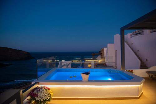 a swimming pool on the side of a house at Myrsini's Luxury Suites Merchia in Mýkonos City