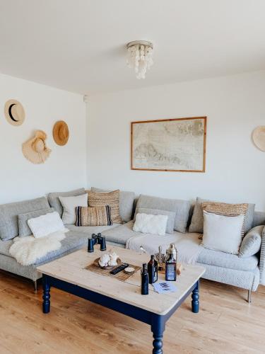 a living room with a couch and a coffee table at East Street Beach House - luxury living by the sea in Ryde