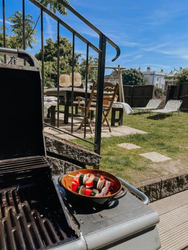 a grill with a bowl of food on it at East Street Beach House - luxury living by the sea in Ryde