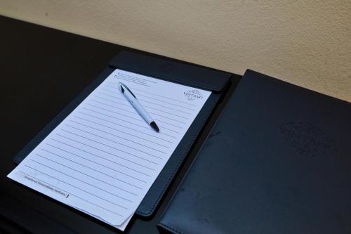 a pen sitting on top of a piece of paper at Vintano Hotel in Lekki