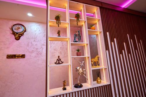 a room with a shelf with vases and a clock at Vintano Hotel in Lekki