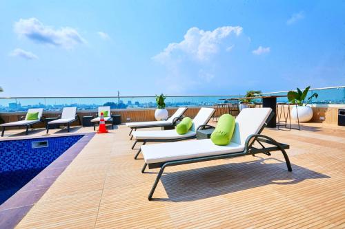 a row of lounge chairs on the roof of a building at Vintano Hotel in Lekki