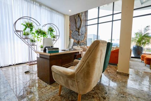 a living room with a desk and a chair at Vintano Hotel in Lekki