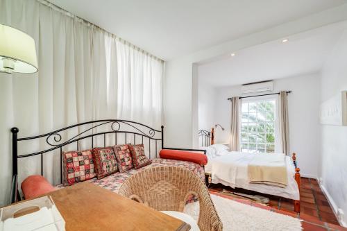a bedroom with a bed and a table at Camps Bay Terrace Palm Suite in Cape Town