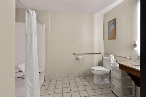 a white bathroom with a toilet and a shower at Comfort Inn & Suites in Fremont